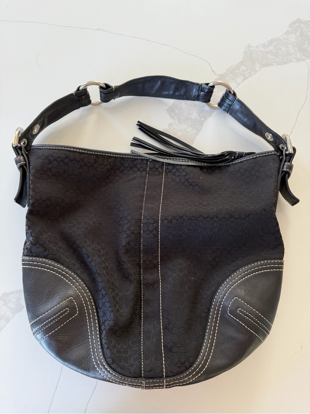 Coach Soho Hobo bag features a black jacquard signature "C"